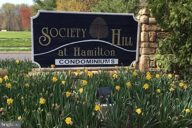 a sign broad in front of the tree