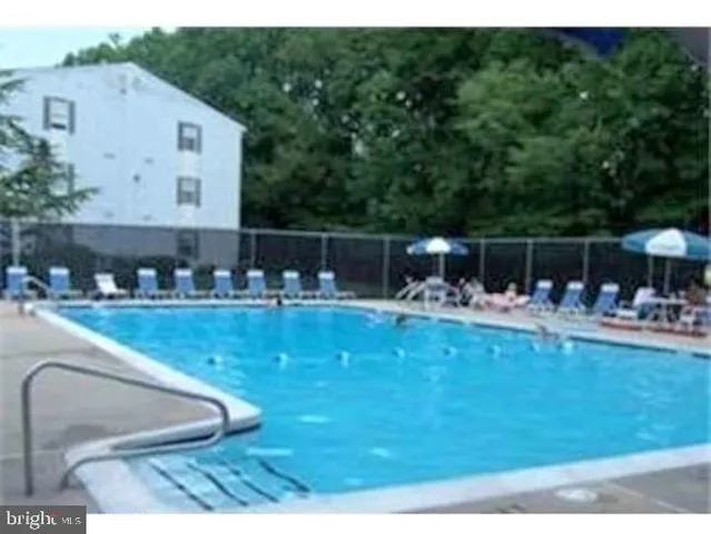 a view of swimming pool with outdoor seating and plants