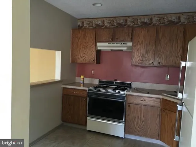 a kitchen with a stove and a sink