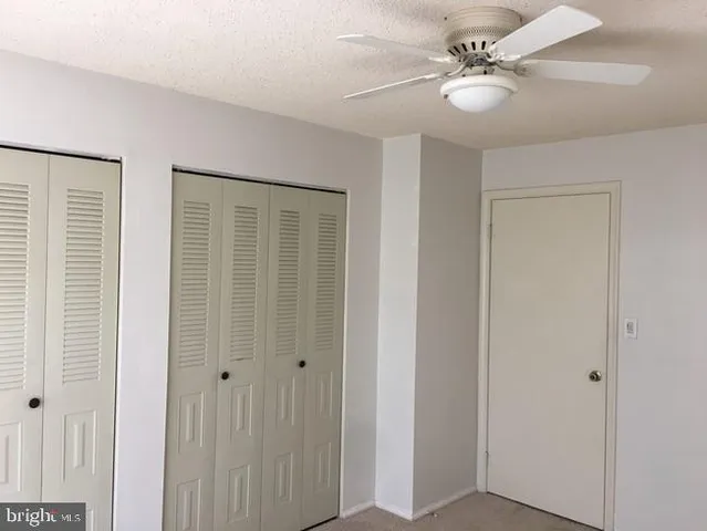 a view of a livingroom with a ceiling fan and a window