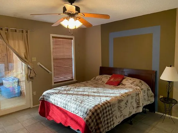 a bedroom with a bed and a chandelier