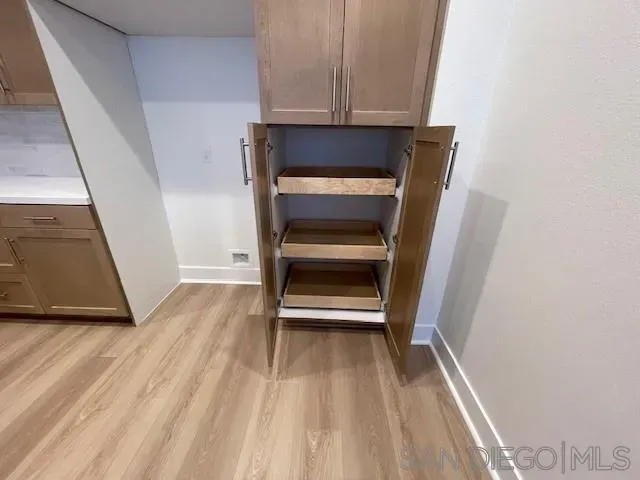 a view of walk in closet with empty racks