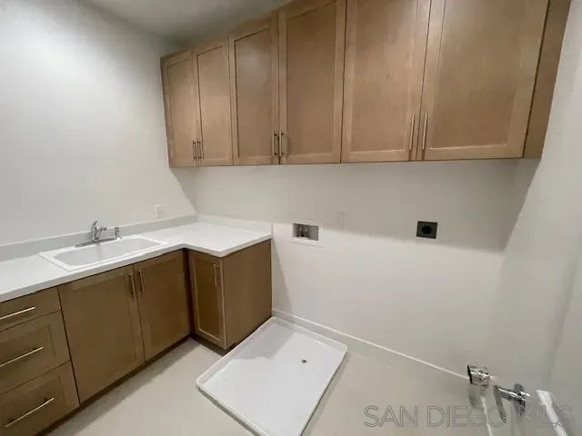 a kitchen with a sink and cabinets