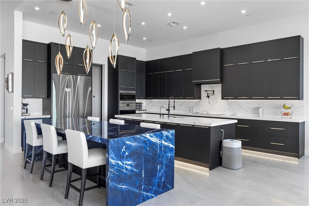 600 Quail Covey Road Henderson, NV 89002 - Photo 25 of 42 Kitchen featuring custom cabinets, and a large island