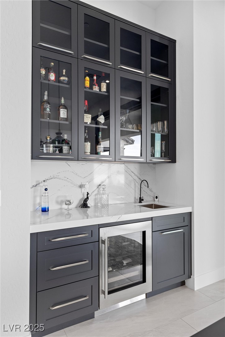 600 Quail Covey Road Henderson, NV 89002 - Photo 27 of 42 Bar featuring beverage cooler, a sink, tasteful backsplash, and indoor wet bar