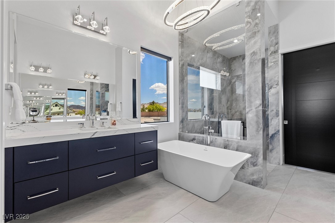 600 Quail Covey Road Henderson, NV 89002 - Photo 30 of 42 Primary bathroom featuring vanity, a walk-in shower and a soaking tub