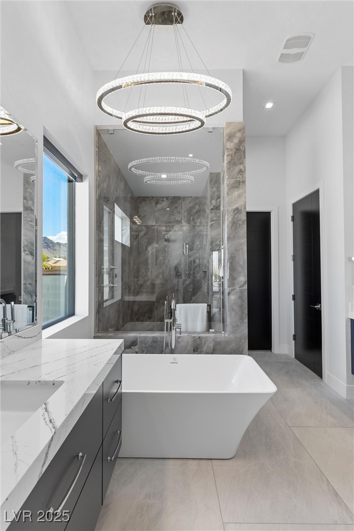 600 Quail Covey Road Henderson, NV 89002 - Photo 31 of 42 Primary bathroom with chandelier hanging over bath tub