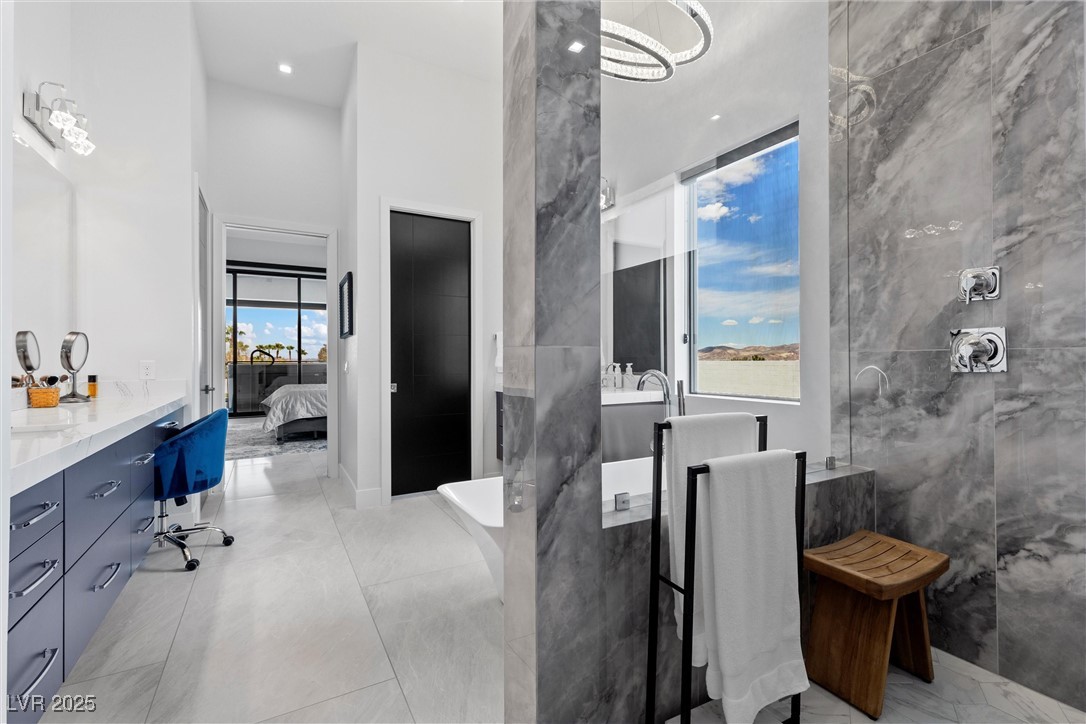 600 Quail Covey Road Henderson, NV 89002 - Photo 32 of 42 Ensuite bathroom with vanity, a high ceiling, ensuite bath, and tiled shower