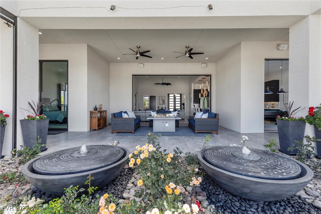 600 Quail Covey Road Henderson, NV 89002 - Photo 33 of 42 View of patio / terrace with an outdoor living space fire pit, and two water fountains.