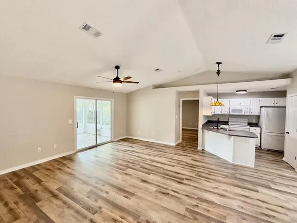 a view of kitchen with sink microwave and stove