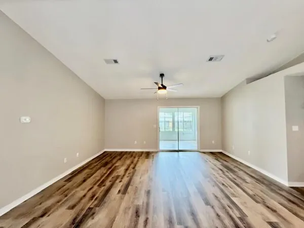 wooden floor in an empty room with a window