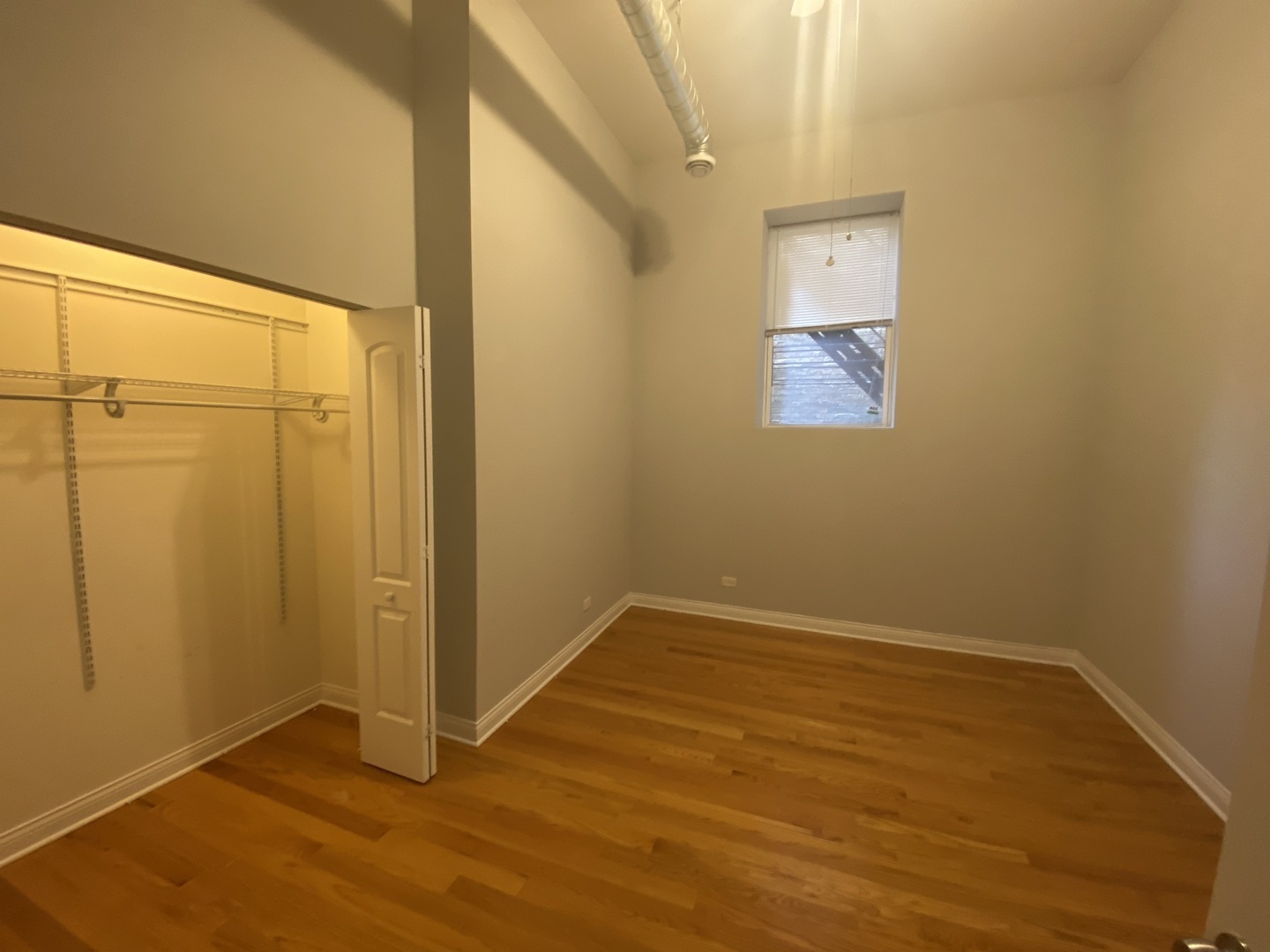 Undisclosed Address Chicago, IL 60613 - Photo 13 of 14 an empty room with wooden floor and windows