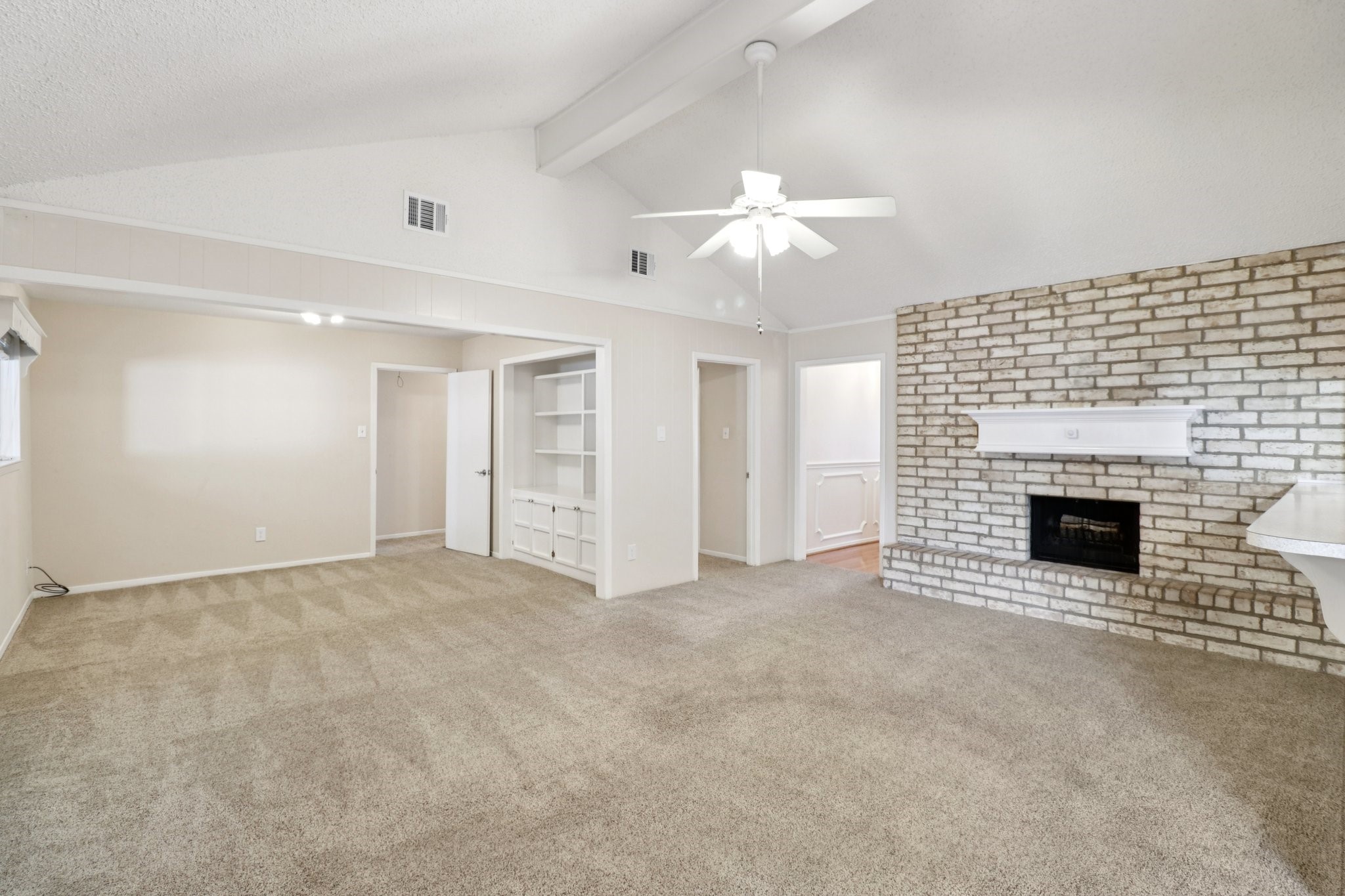 11118 Cedarview Lane Houston, TX 77041 - Photo 2 of 15 an empty room with a fireplace and chandelier fan