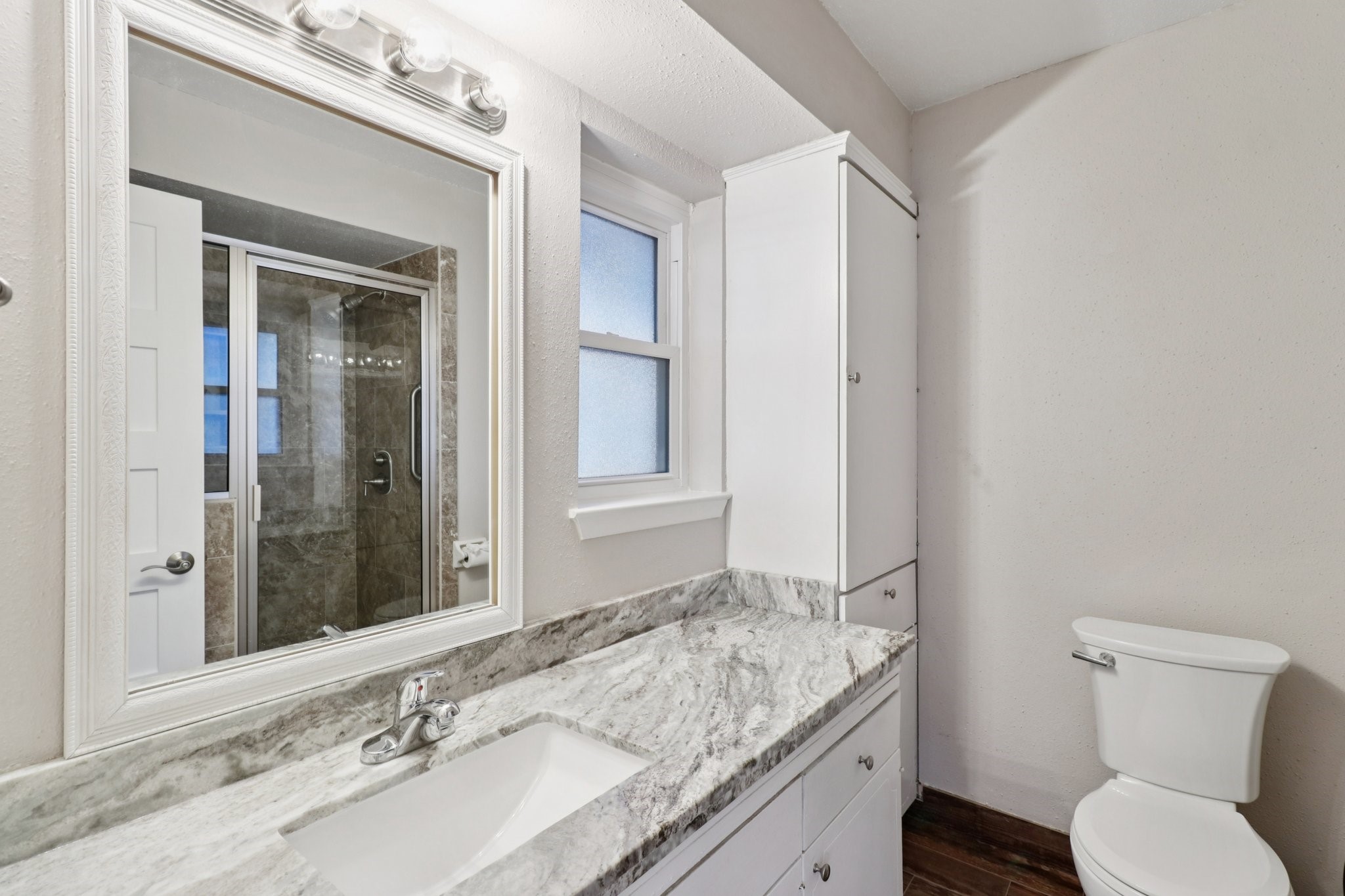 11118 Cedarview Lane Houston, TX 77041 - Photo 9 of 15 a bathroom with a granite countertop sink toilet and shower