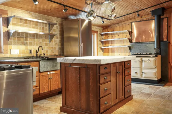 a kitchen with stainless steel appliances granite countertop a sink and cabinets