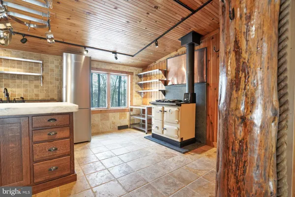 a kitchen with stove and cabinets