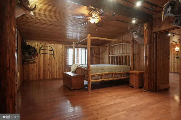 a bed sitting in a spacious bedroom next to a window