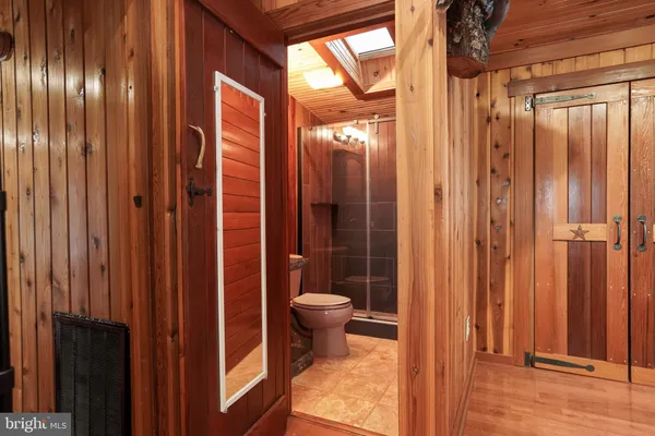 a bathroom with a granite countertop toilet and a sink