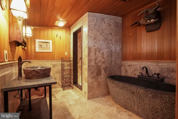 a bathroom with a granite countertop shower and a sink