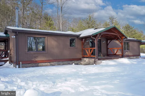 a view of house with outdoor space and trees