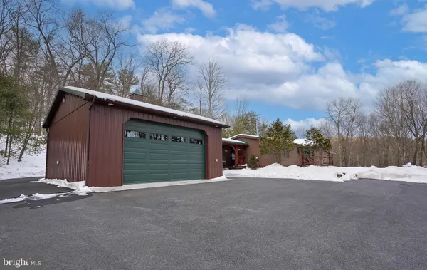 a view of a house with a wooden fence