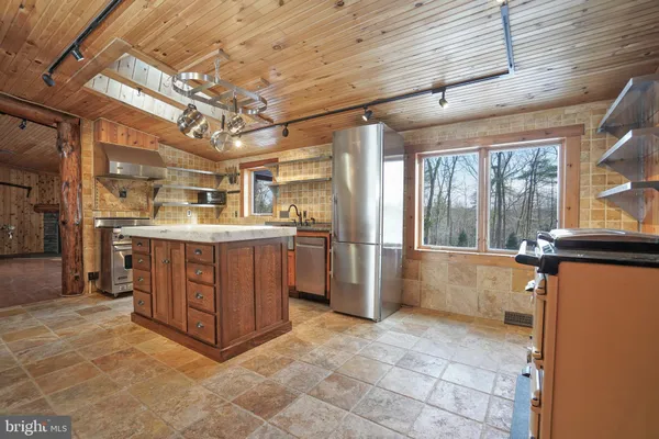 a large kitchen with stainless steel appliances and a stove