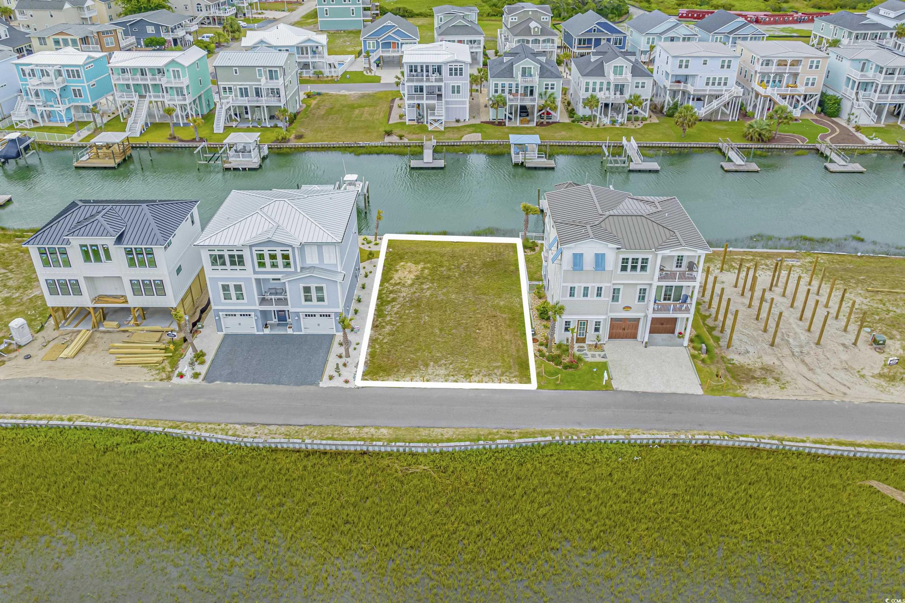 1310 Riverside Drive Sunset Beach, NC 28468 - Photo 2 of 13 Aerial perspective of suburban area with a large b