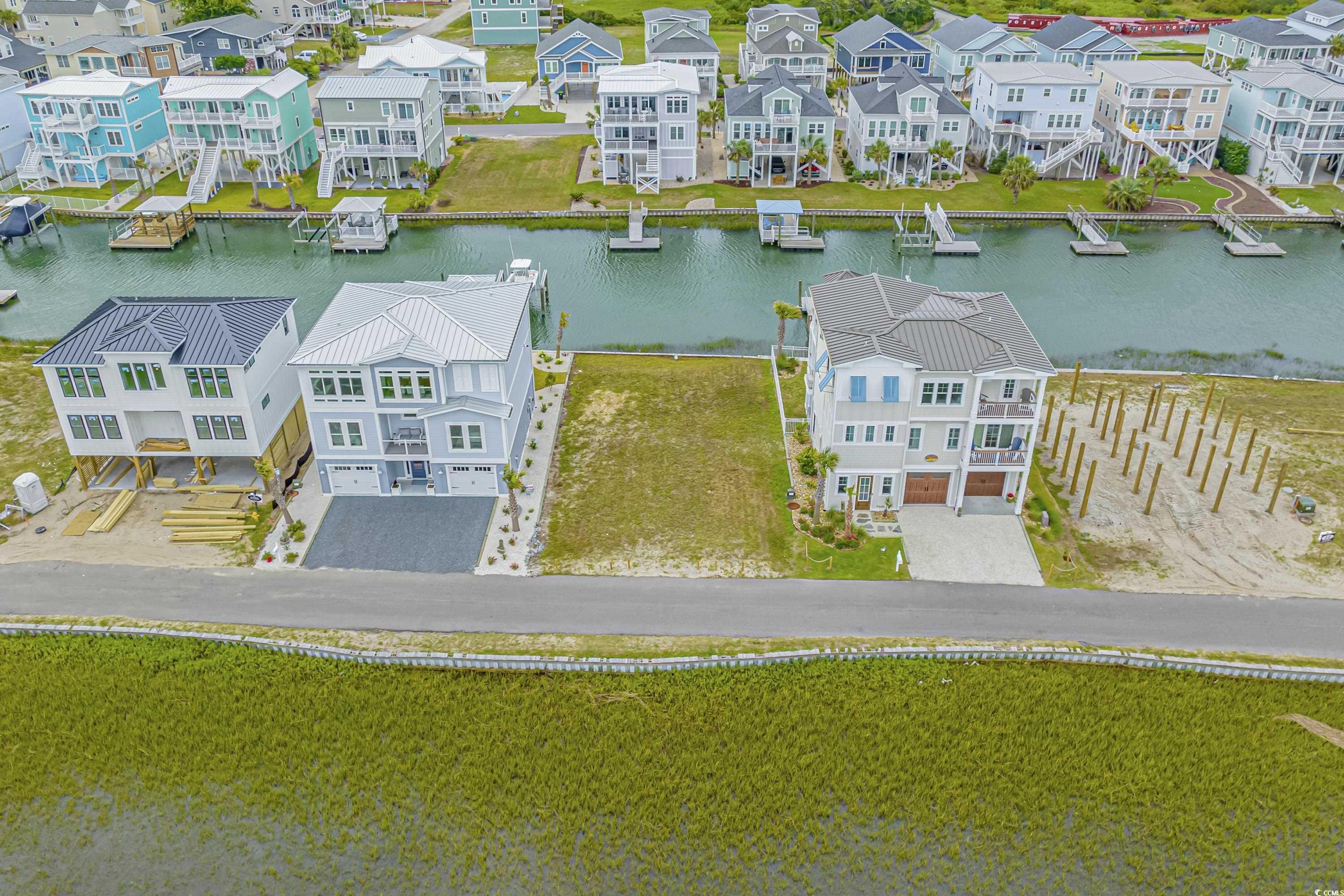 1310 Riverside Drive Sunset Beach, NC 28468 - Photo 3 of 13 Aerial view of residential area with a large body
