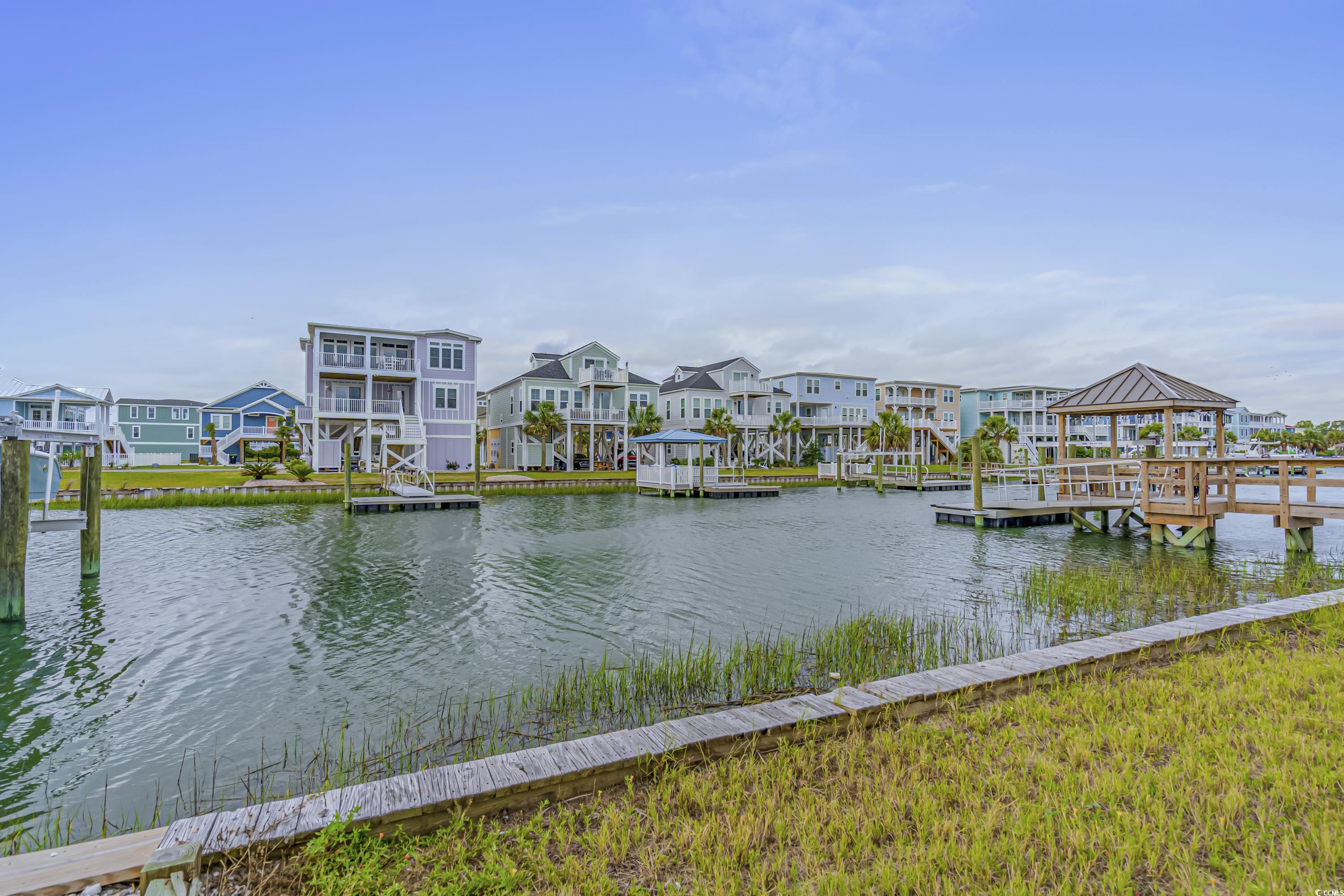 1310 Riverside Drive Sunset Beach, NC 28468 - Photo 9 of 13 Dock area with a residential view and a water view