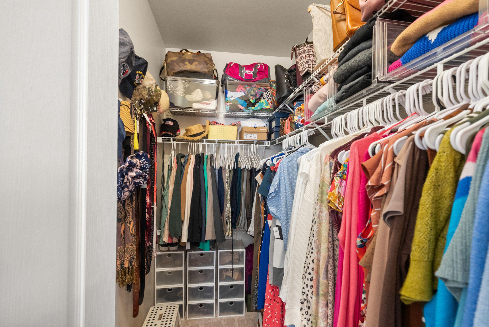 12414 A Liberty Bridge Road Fairfax, VA 22033 - Photo 20 of 38 a view of walk in closet with clothes and shoes
