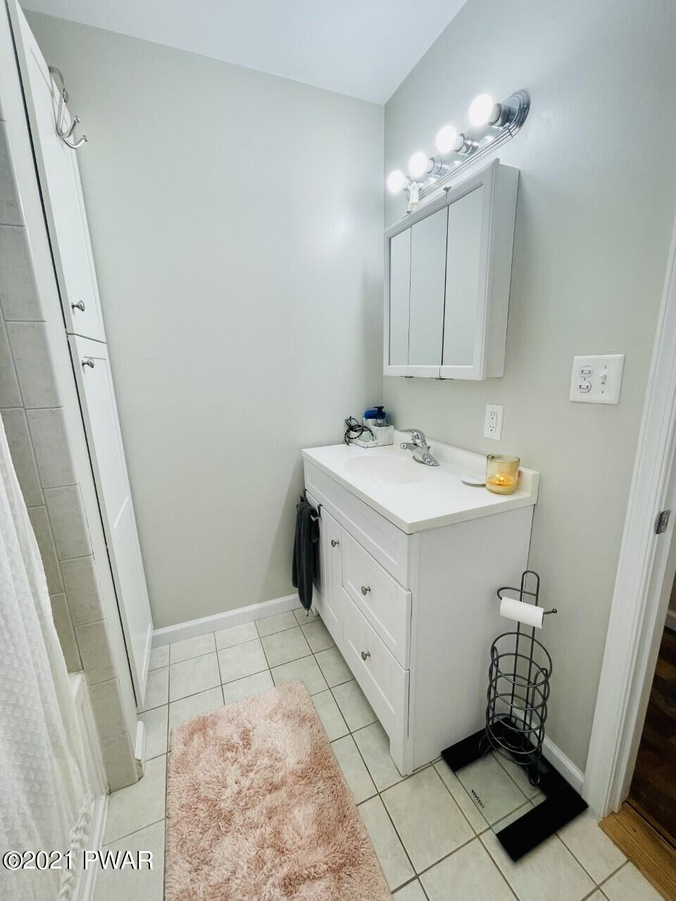 149 Walker Lake Road Shohola, PA 18458 - Photo 12 of 51 a bathroom with a sink a vanity and a mirror