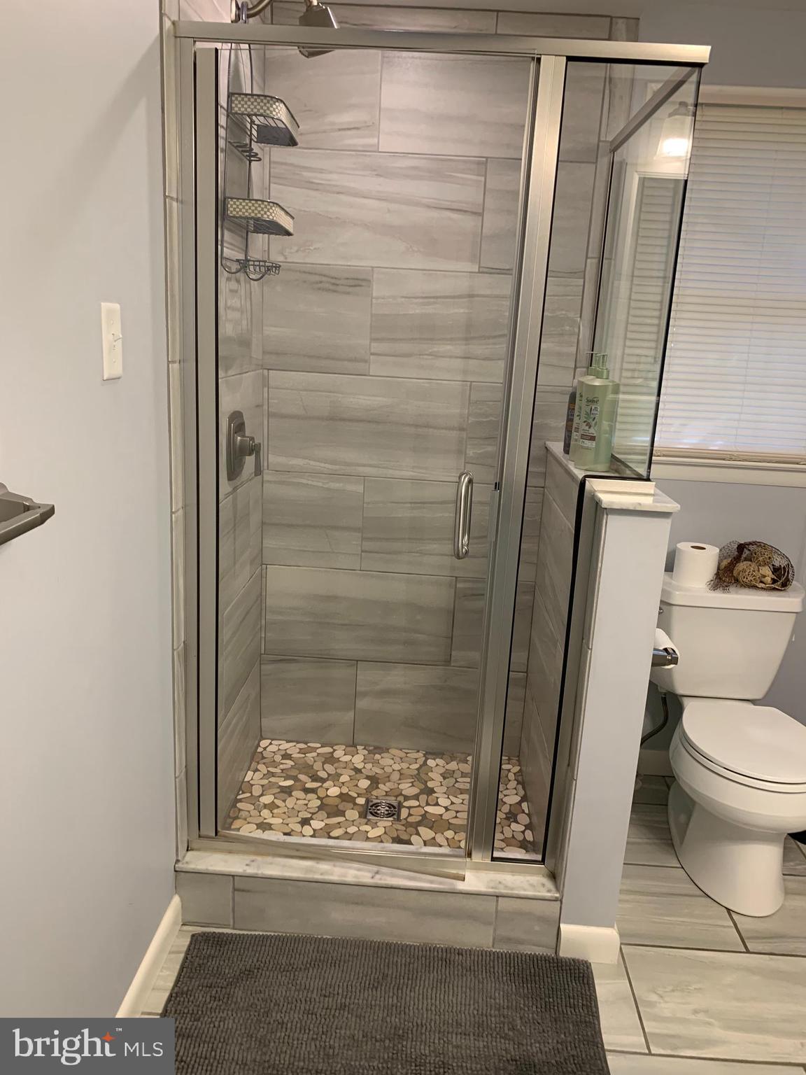 2605 Harrington Road Chester, MD 21619 - Photo 11 of 27 a bathroom with a shower and a toilet