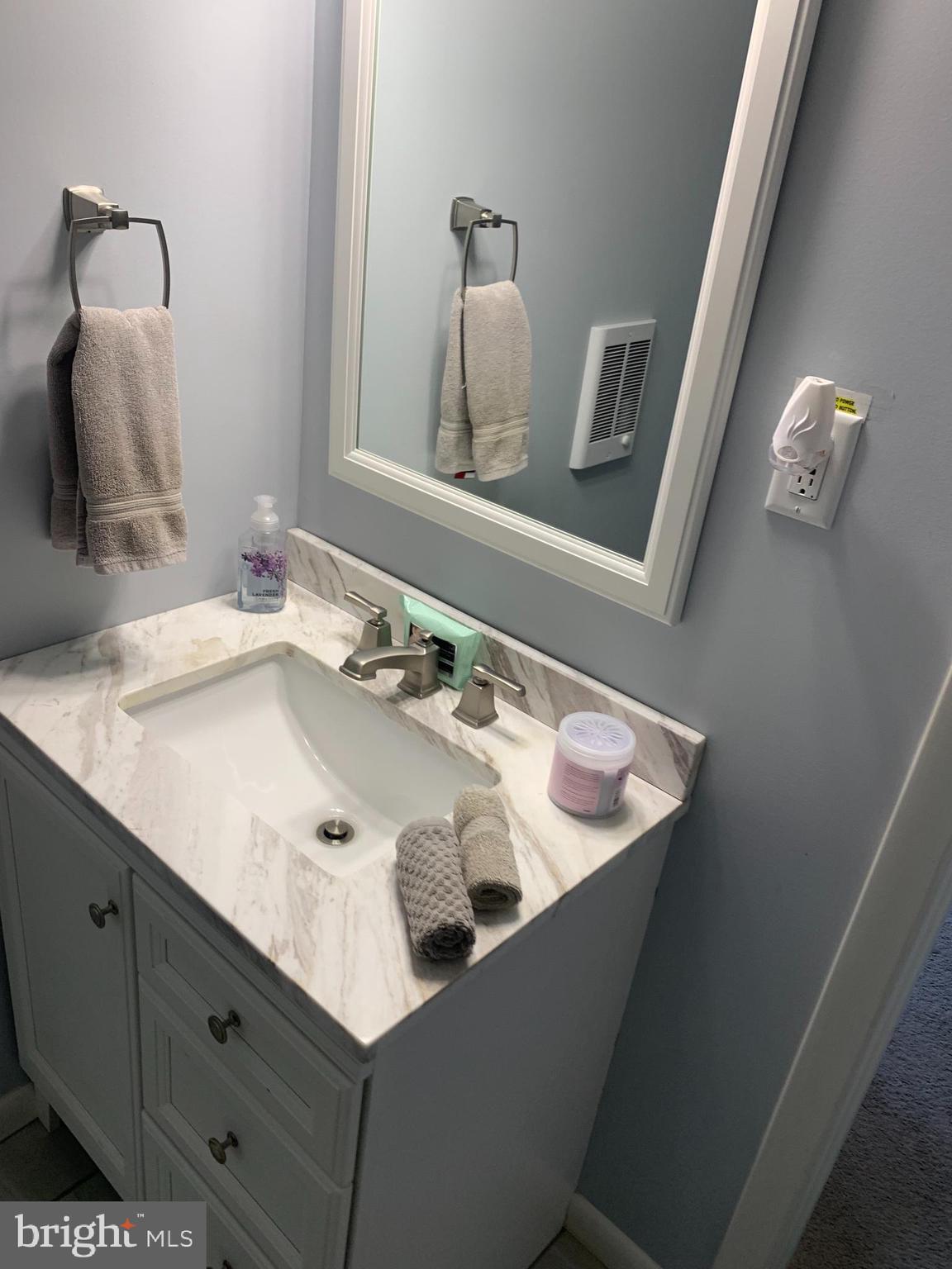 2605 Harrington Road Chester, MD 21619 - Photo 12 of 27 a bathroom with a sink and a mirror