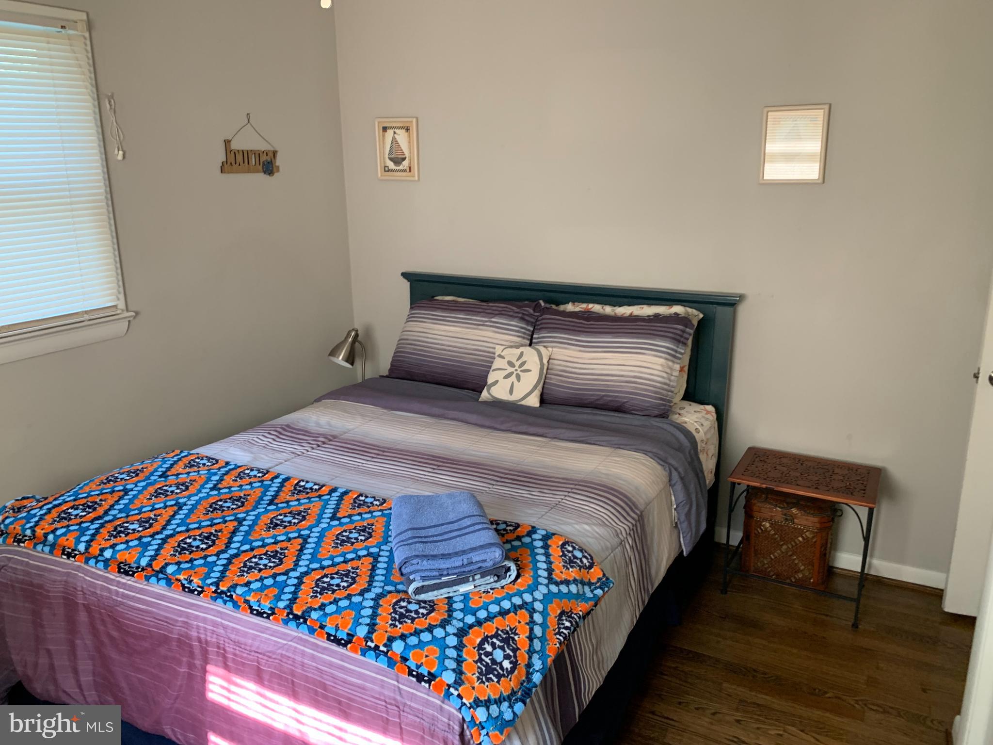 2605 Harrington Road Chester, MD 21619 - Photo 16 of 27 a bedroom with a bed and a lamp on table