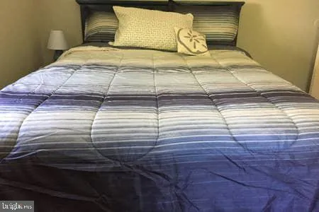 a bed sitting in a bedroom next to a lamp