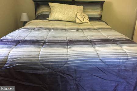 2605 Harrington Road Chester, MD 21619 - Photo 16 of 29 a bed sitting in a bedroom next to a window