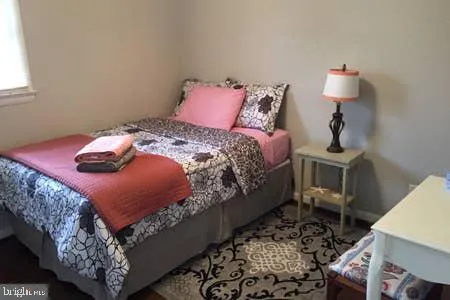 a bed sitting in a bedroom next to a window