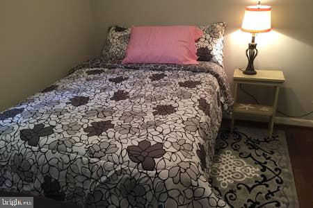 2605 Harrington Road Chester, MD 21619 - Photo 18 of 29 a bed sitting in a bedroom next to a lamp