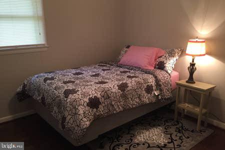 2605 Harrington Road Chester, MD 21619 - Photo 19 of 29 a bed sitting in a bedroom next to a window