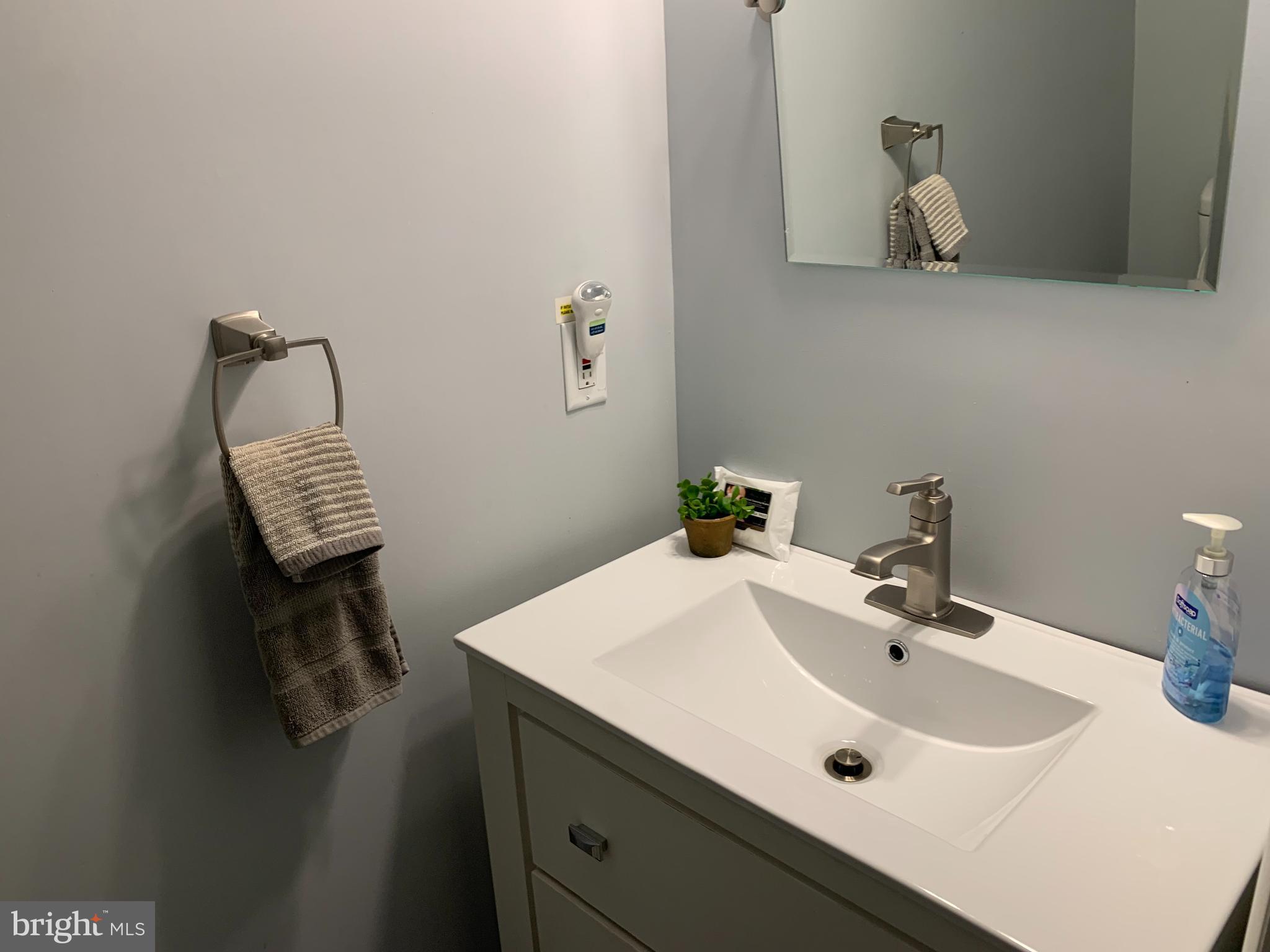 2605 Harrington Road Chester, MD 21619 - Photo 24 of 27 a bathroom with a sink and a mirror