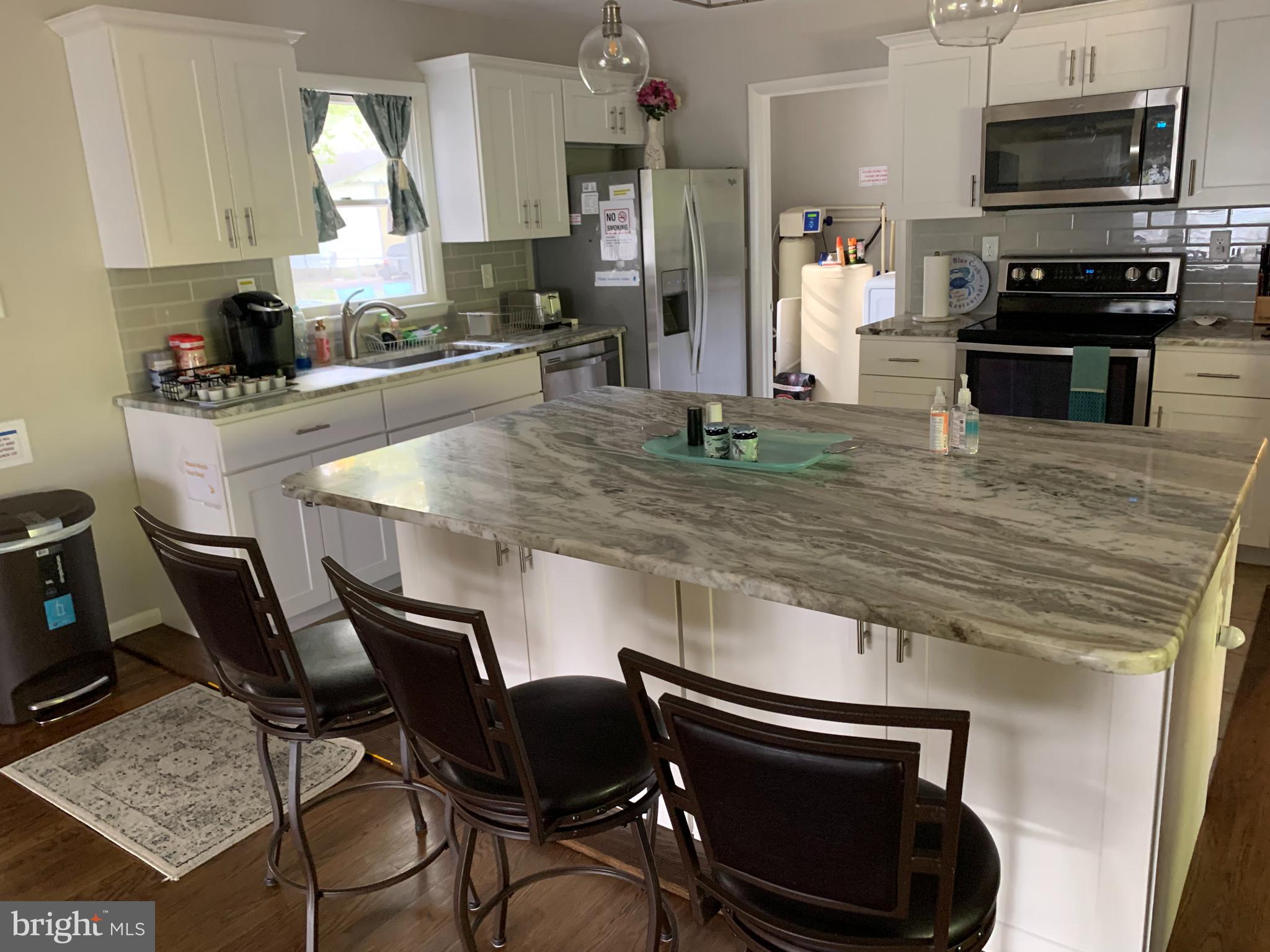 2605 Harrington Road Chester, MD 21619 - Photo 4 of 27 a kitchen with kitchen island a stove and a sink