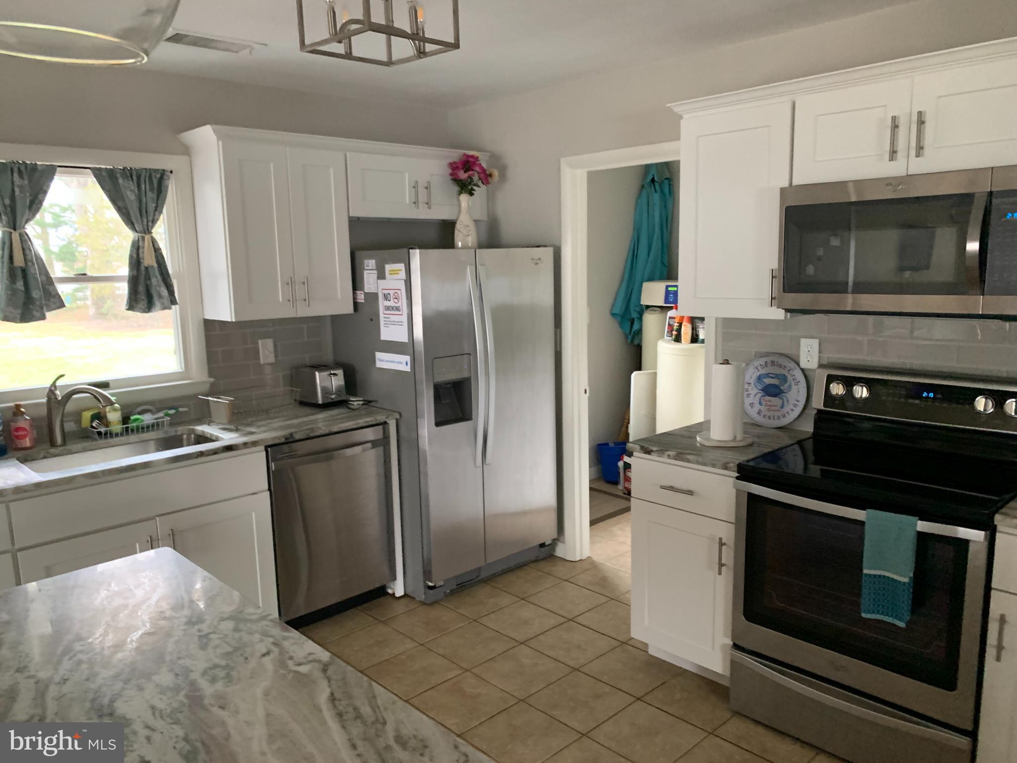2605 Harrington Road Chester, MD 21619 - Photo 5 of 27 a kitchen with a stove microwave and refrigerator