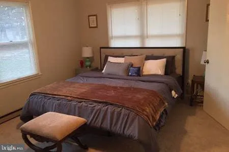 a view of a hallway with a table and a mirror