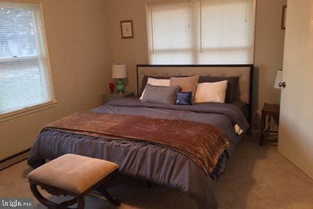 2605 Harrington Road Chester, MD 21619 - Photo 9 of 29 a bedroom with a bed a dresser and chair