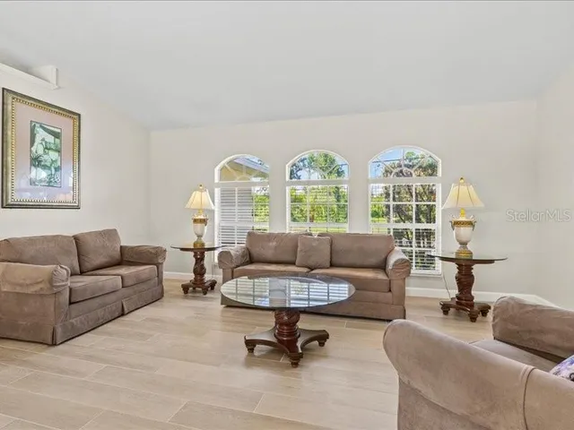 a view of a dining room with furniture a chandelier and wooden floor
