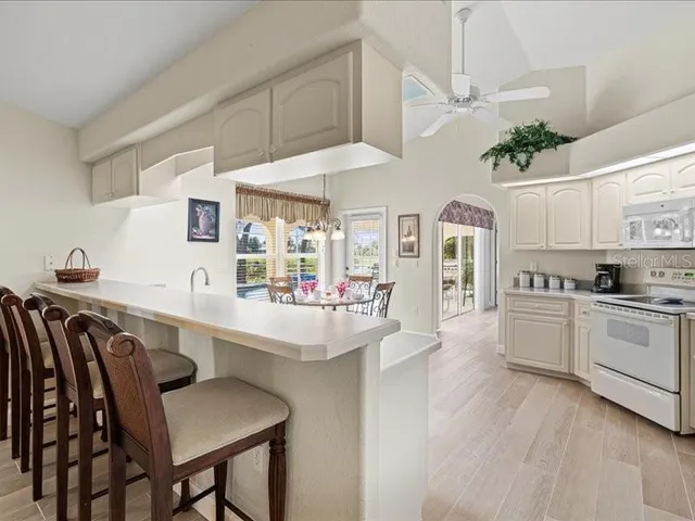 a living room with furniture and a flat screen tv with wooden floor