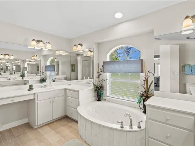 a bedroom with two beds and a chandelier