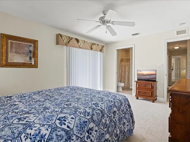 a living room with furniture a chandelier and a large window