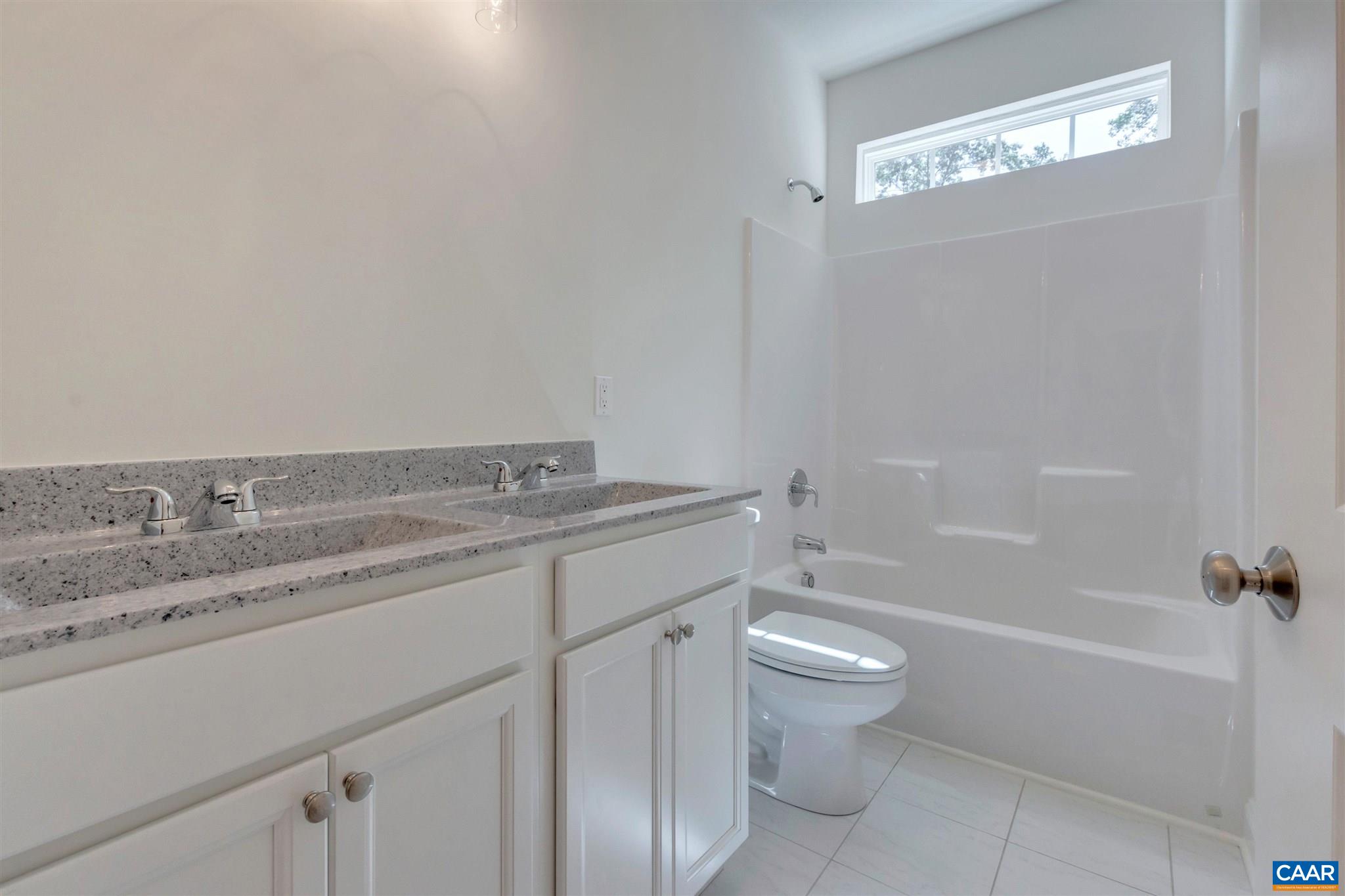 312 Jonquil Road Ruckersville, VA 22968 - Photo 13 of 34 a bathroom with a granite countertop sink a toilet and shower