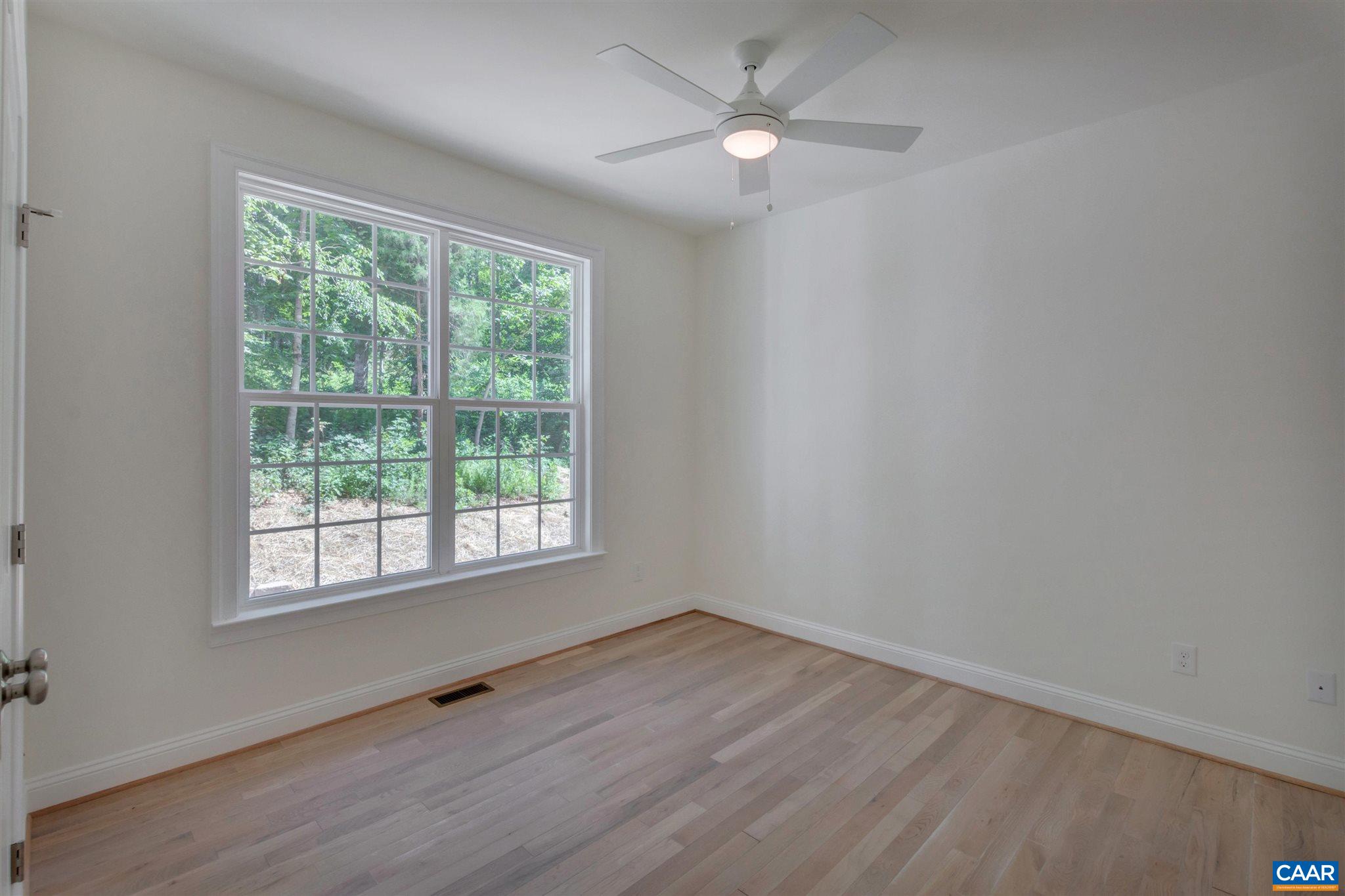 312 Jonquil Road Ruckersville, VA 22968 - Photo 15 of 34 wooden floor in an empty room with a window